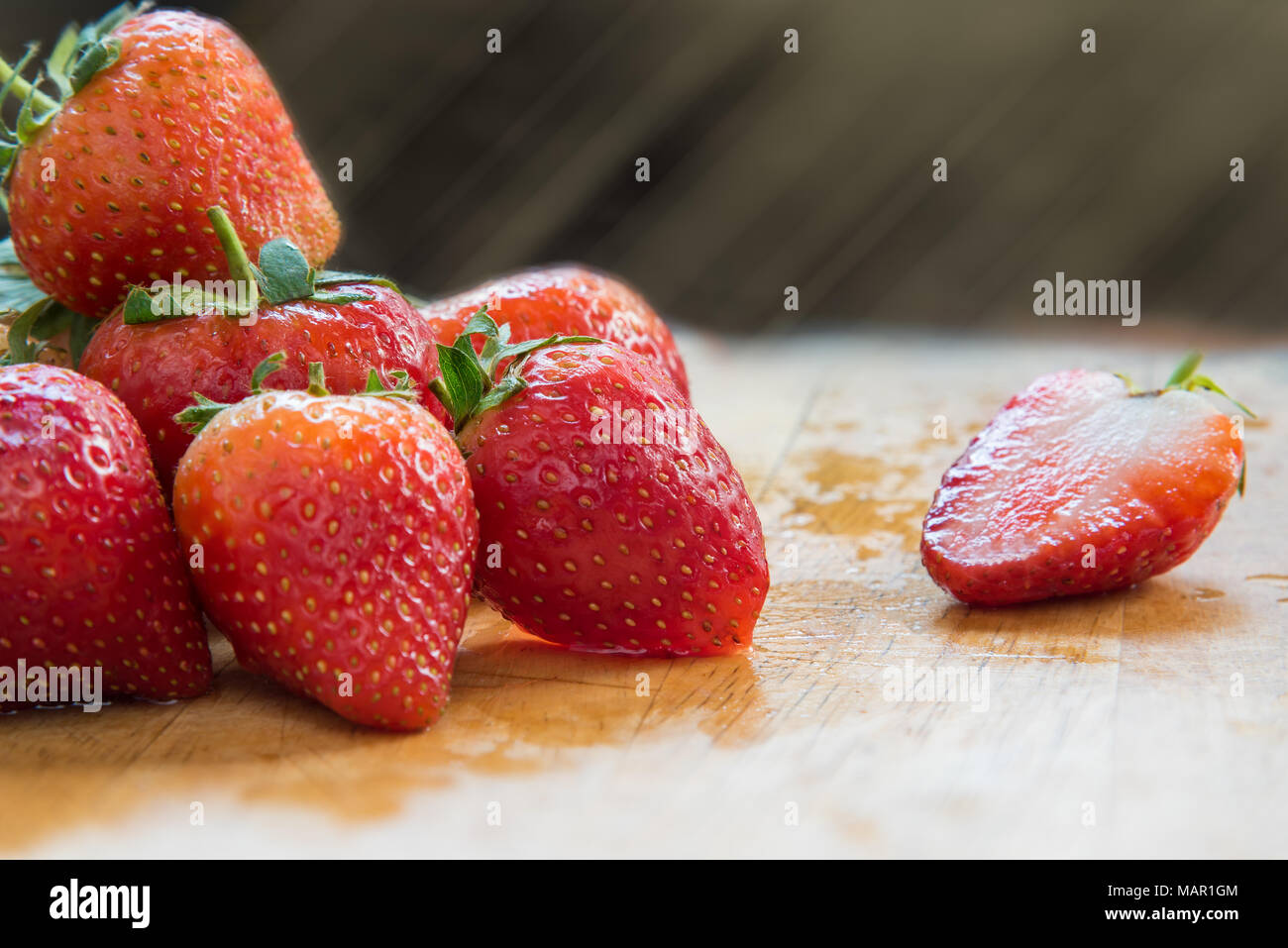 Strawberries on wooden table, with light rays, Fruit and food concept Stock Photo