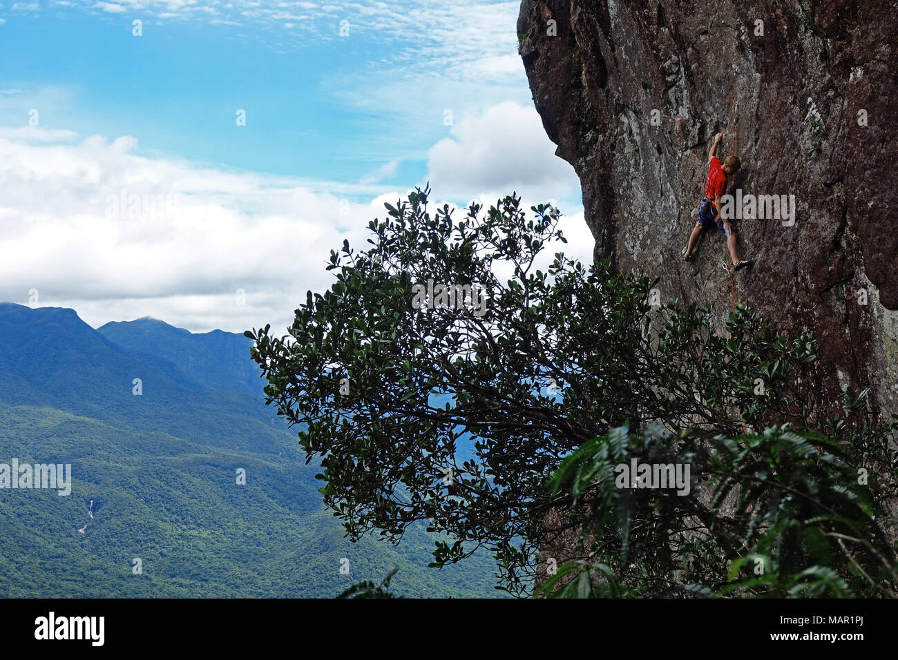 A rock climber scales the famous granite cliffs of Marumbi, a mountain in Parana State, south Brazil, South America Stock Photo