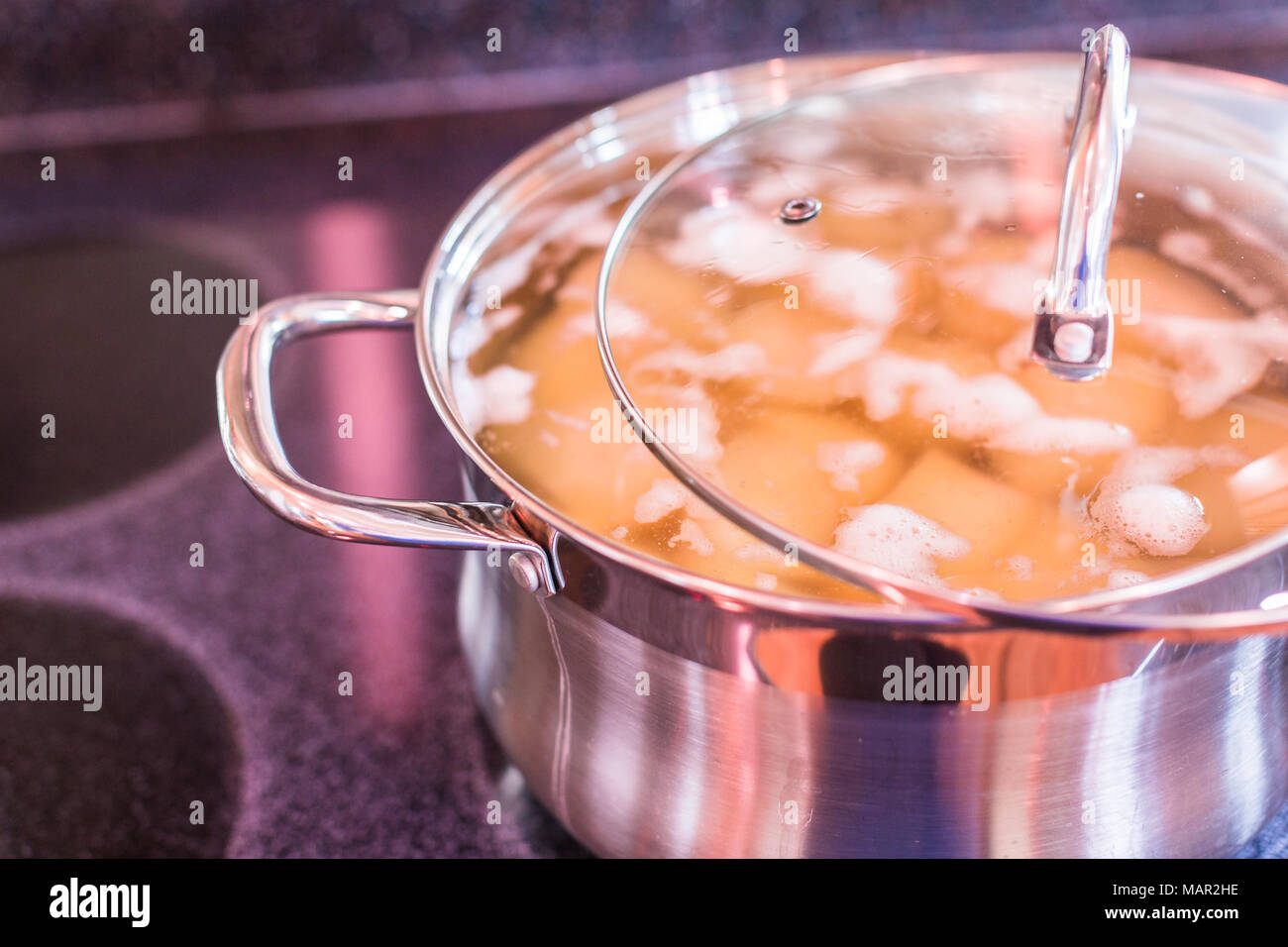 Boiling potatoes in large cooking pot on electric stove Stock Photo Alamy