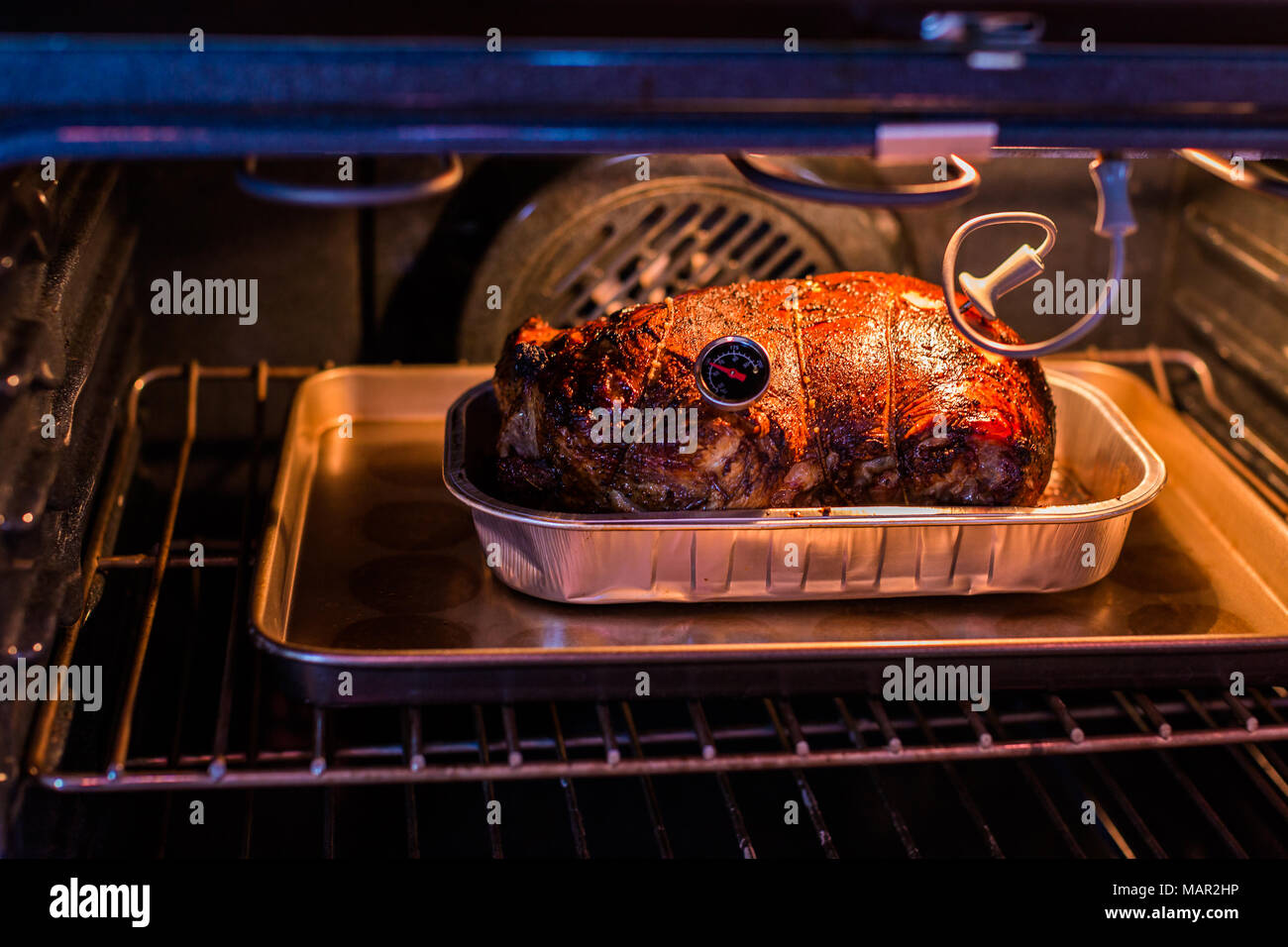 Cooking lamb roast in residential oven Stock Photo - Alamy