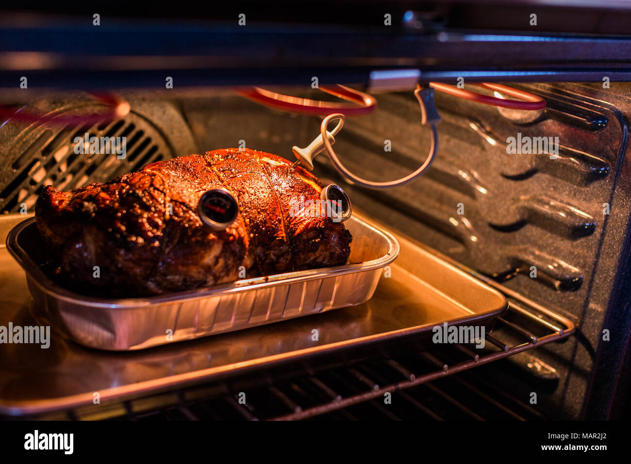 Cooking lamb roast in residential oven Stock Photo - Alamy