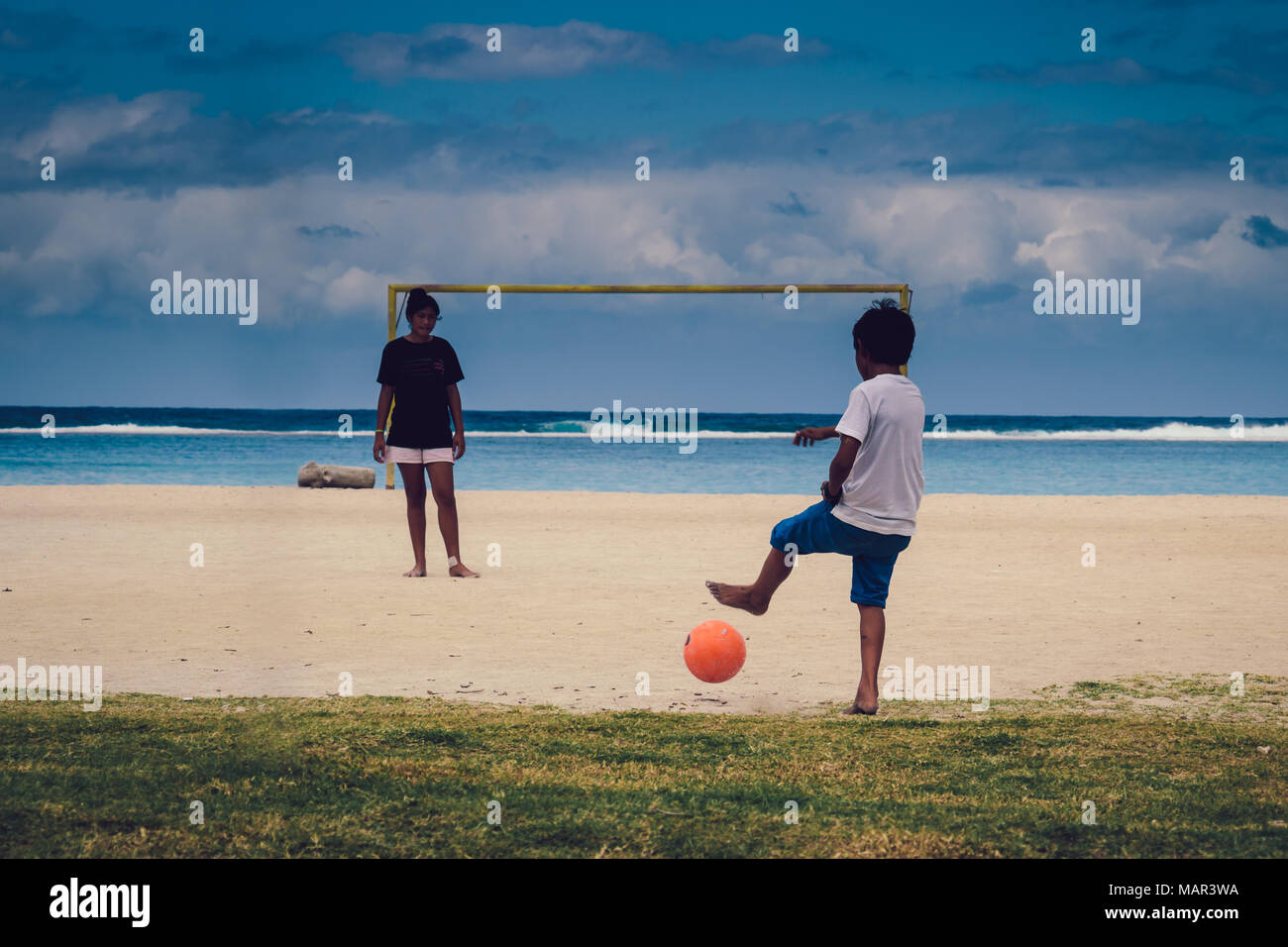 Bora Bora (French Polynesia) - Teenagers playing fottball on the beach Stock Photo