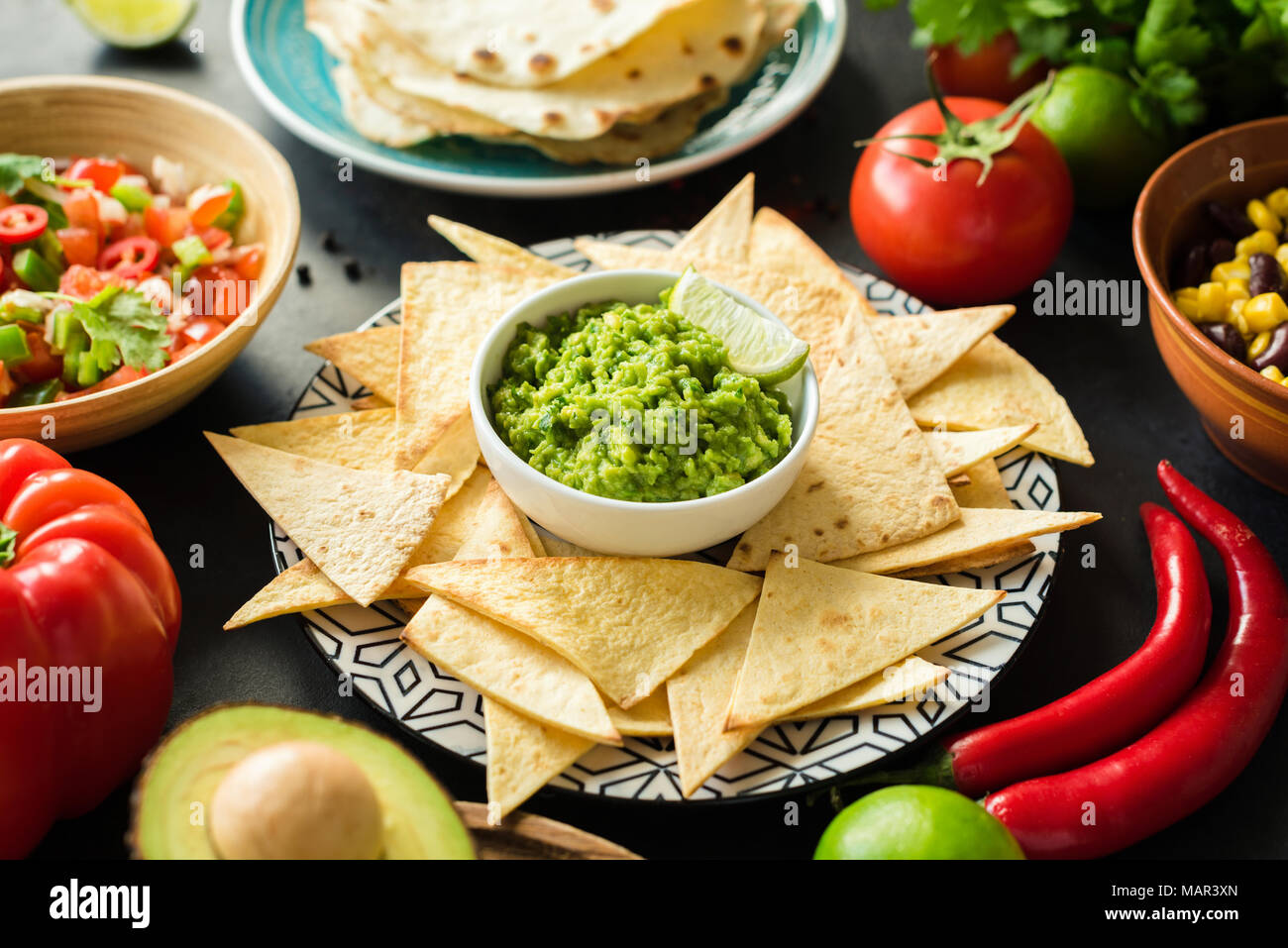 Guacamole, tortilla chips and salsa. Mexican food selection. Closeup