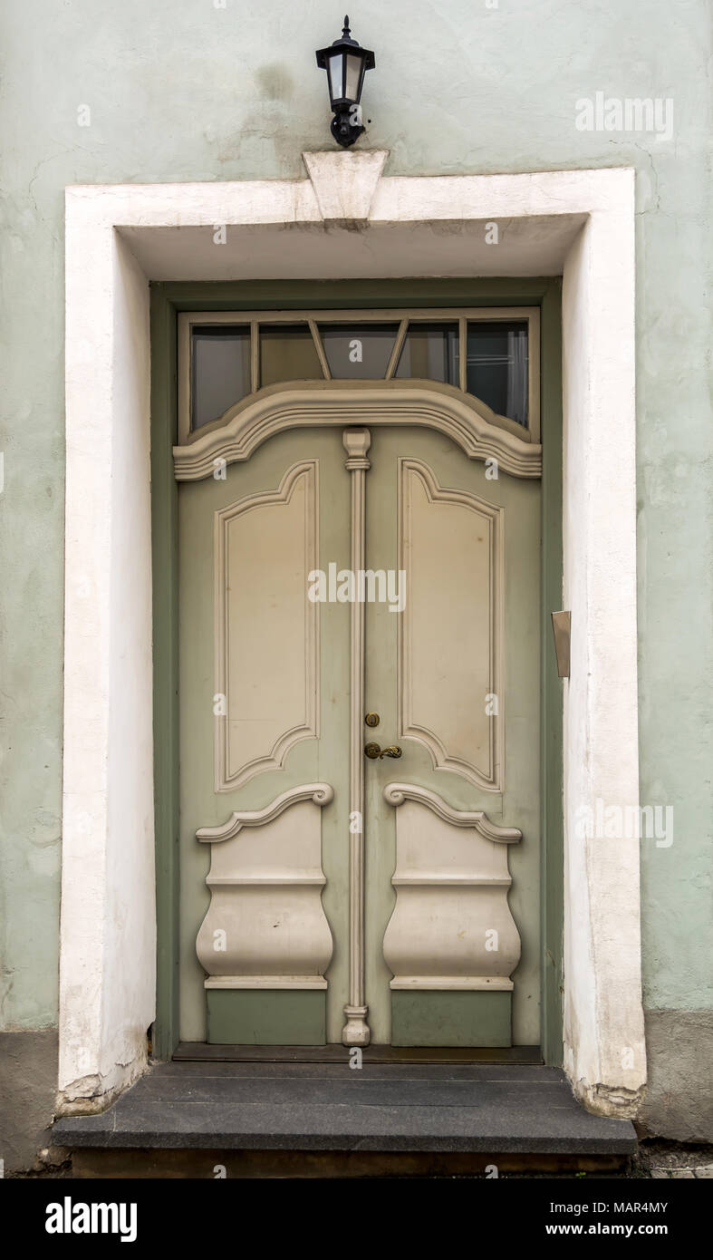 Green vintage front door with glass window Stock Photo