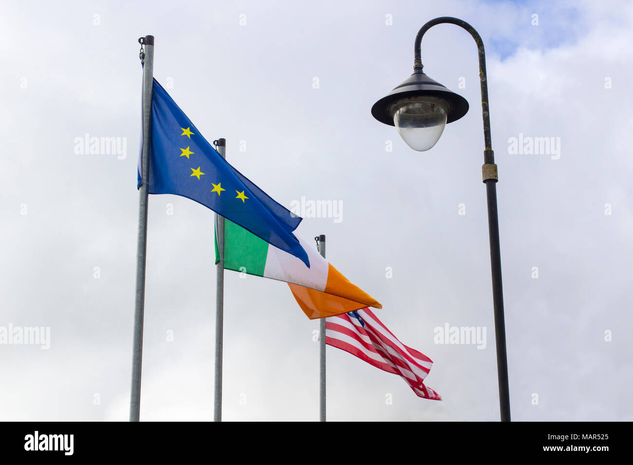 The Irish, American and European Union flags flying together in the Irish town of Blarney in County Cork Stock Photo