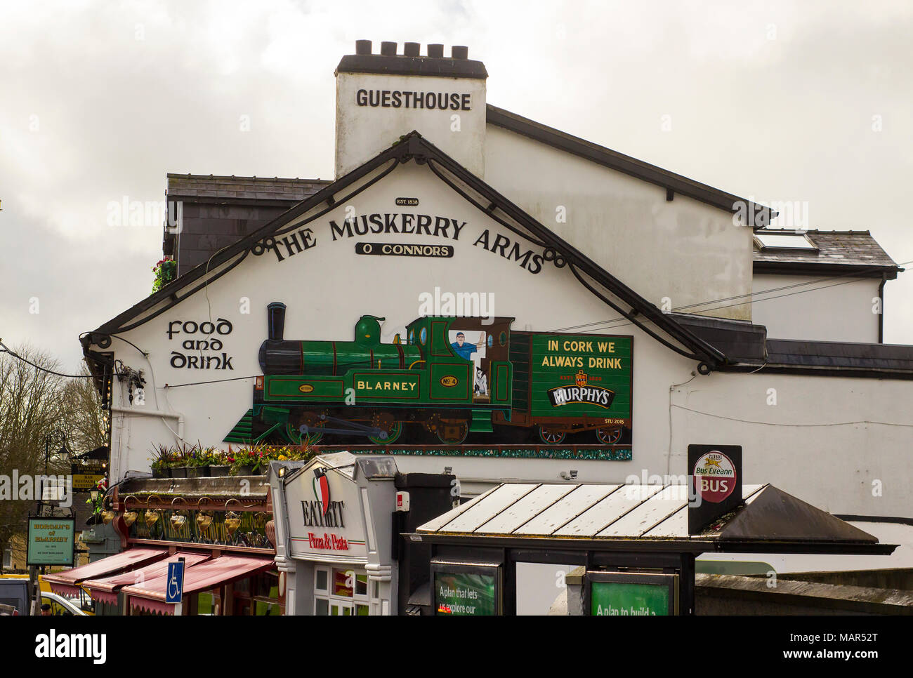 Blarney County Cork Ireland The signage on the gable wall of the Muskerry Arms a traditional Irish Pub on the main street of the town Stock Photo