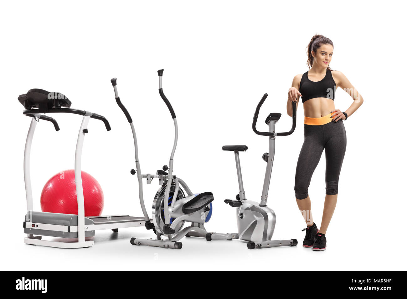 Full length portrait of a fitness woman with exercise machines isolated on white background Stock Photo