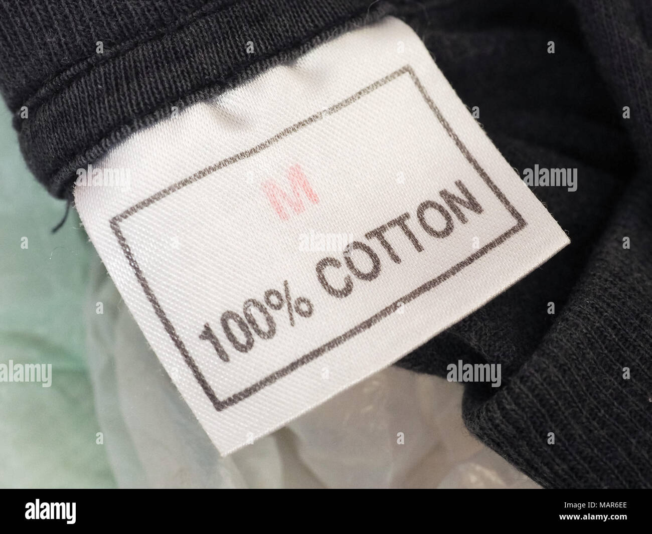 One hundred percent cotton label tag on clothing Stock Photo - Alamy