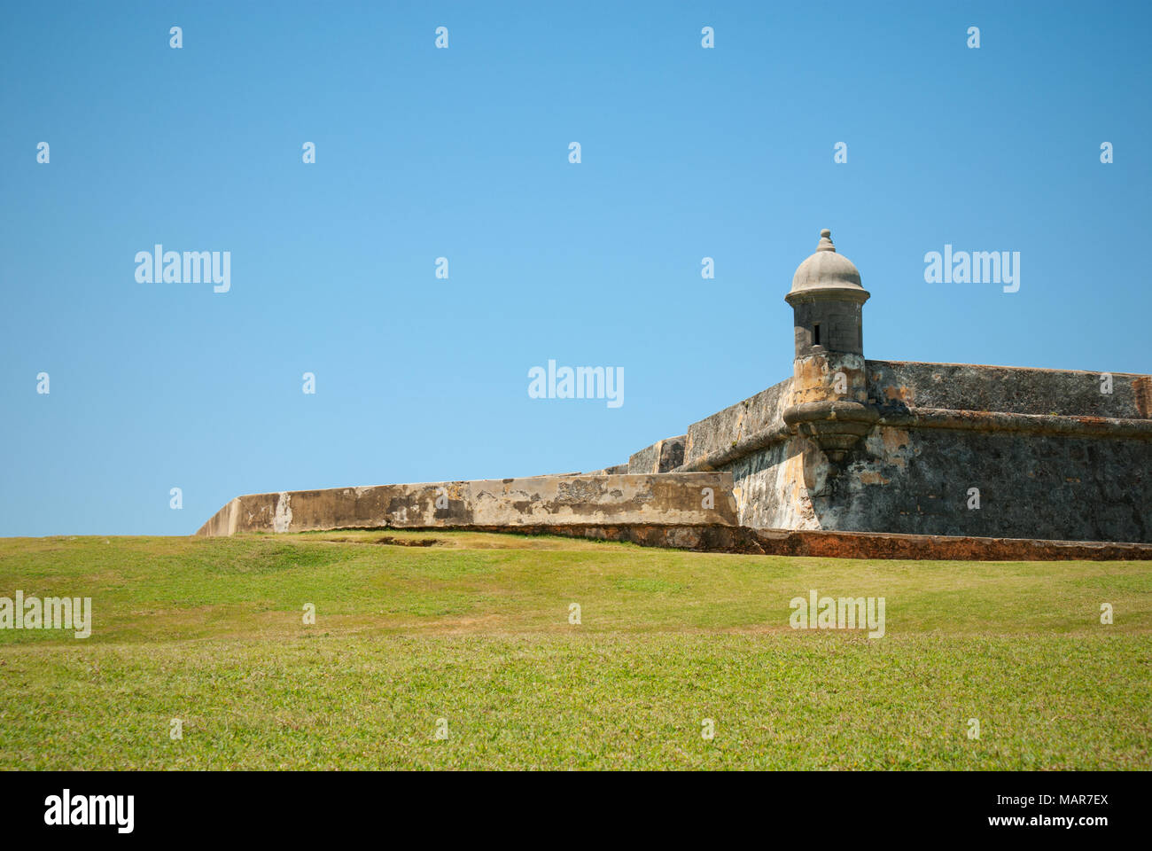 Green plains and part of Castillo San Felipe del Morro in San Juan, Puerto Rico Stock Photo