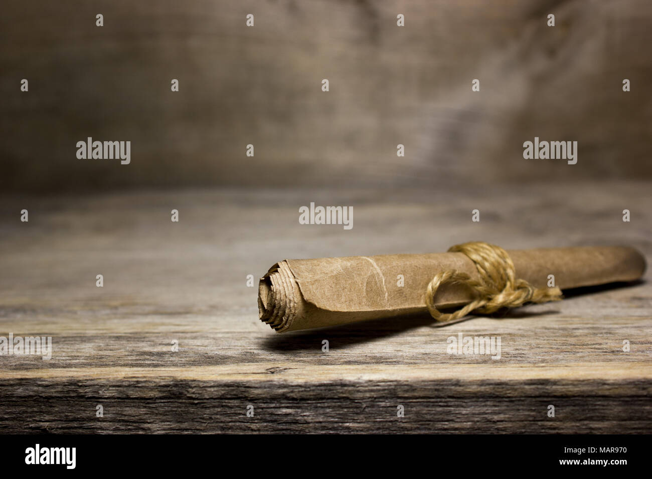 Paper scroll on the wooden table. Stock Photo