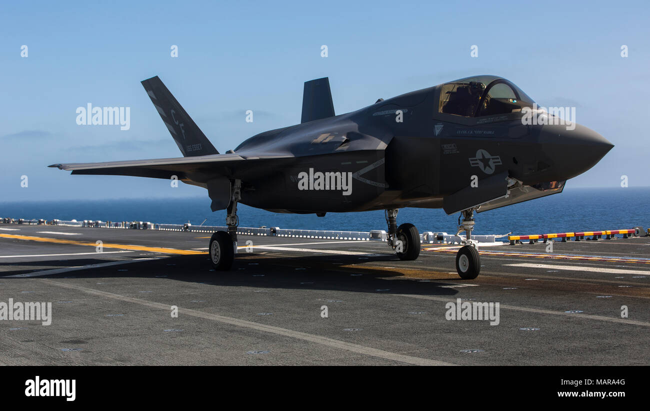 An F-35B from Marine Fighter Attack Squadron-211, 13th Marine Expeditionary Unit (MEU), prepares to take off for flight operations aboard the Wasp-class Amphibious ship USS Essex (LHD 2) March 28, 2018. The Essex Amphibious Ready Group and 13th MEU fully integrated for the first time before their summer deployment. Amphibious Squadron, MEU integration training is a crucial pre-deployment exercise that allows the Navy-Marine Corps team to rapidly plan and execute complex operations from naval shipping. (U.S. Marine Corps photo by Cpl. A. J. Van Fredenberg) Stock Photo