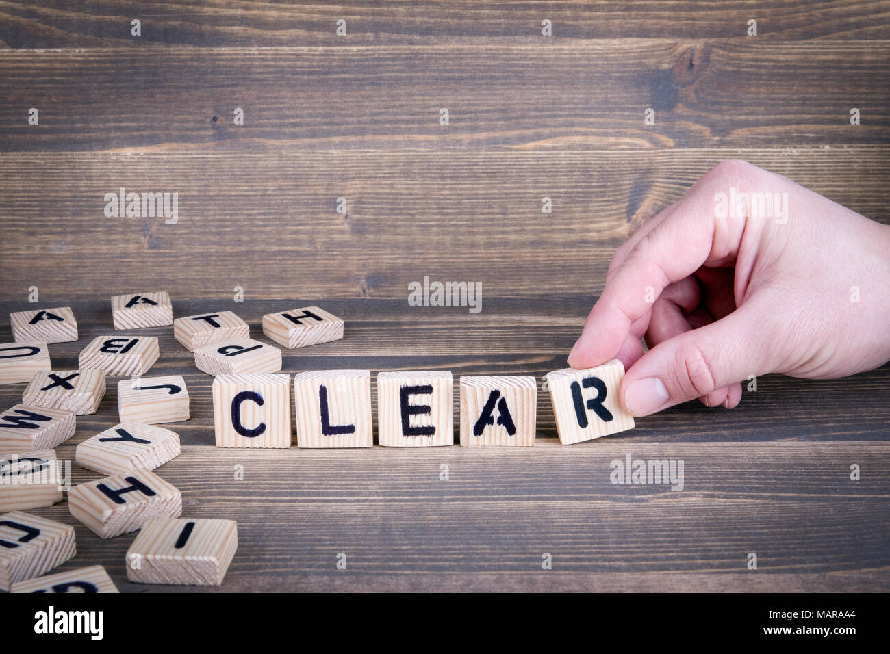 Clear. Wooden letters on the office desk, informative and communication background Stock Photo