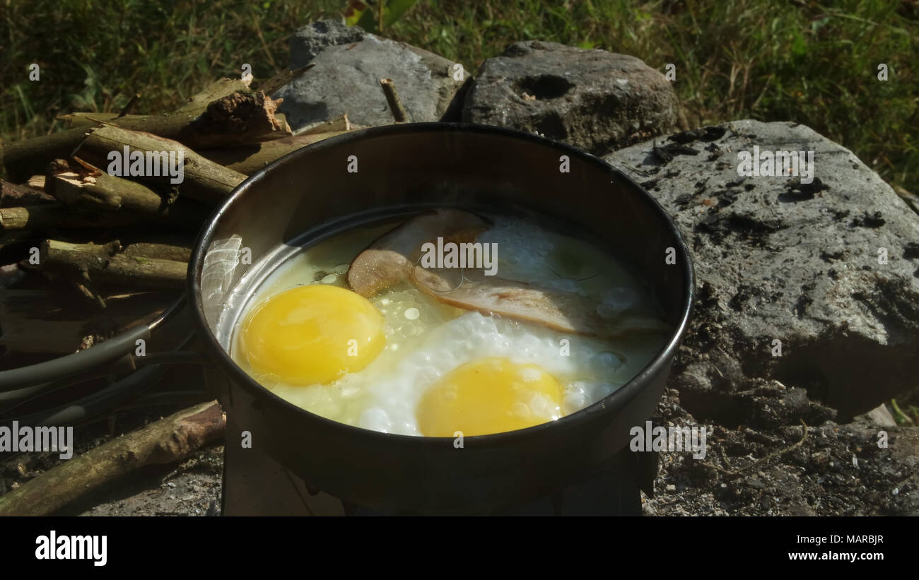 Cooking eggs outdoor Stock Photo - Alamy