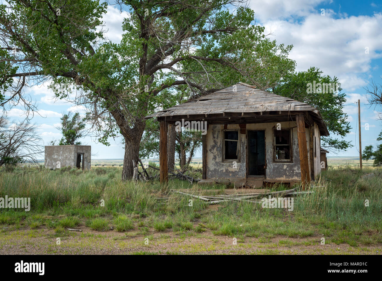Abandoned small house/ruin in rural area. Desert in the background. Stock Photo