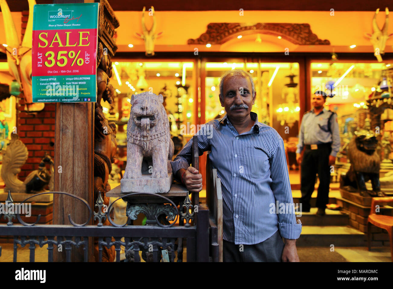 Bangalore, India - October 16, 2016: Unknown old man standing in front of his shop at MG Road, Bangalore. Stock Photo