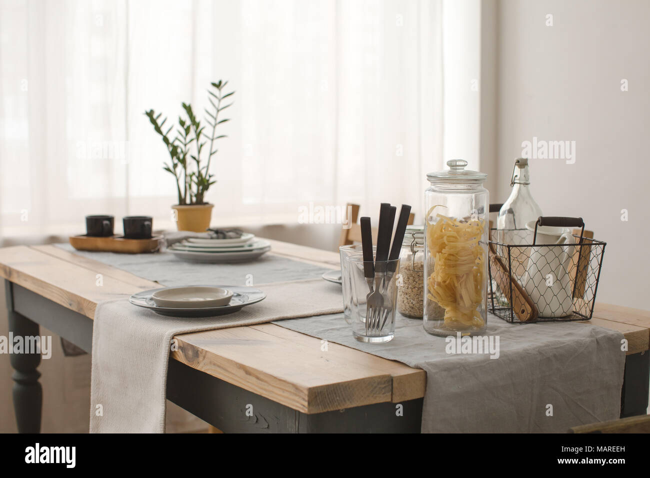 Served table and potted plant morning Stock Photo