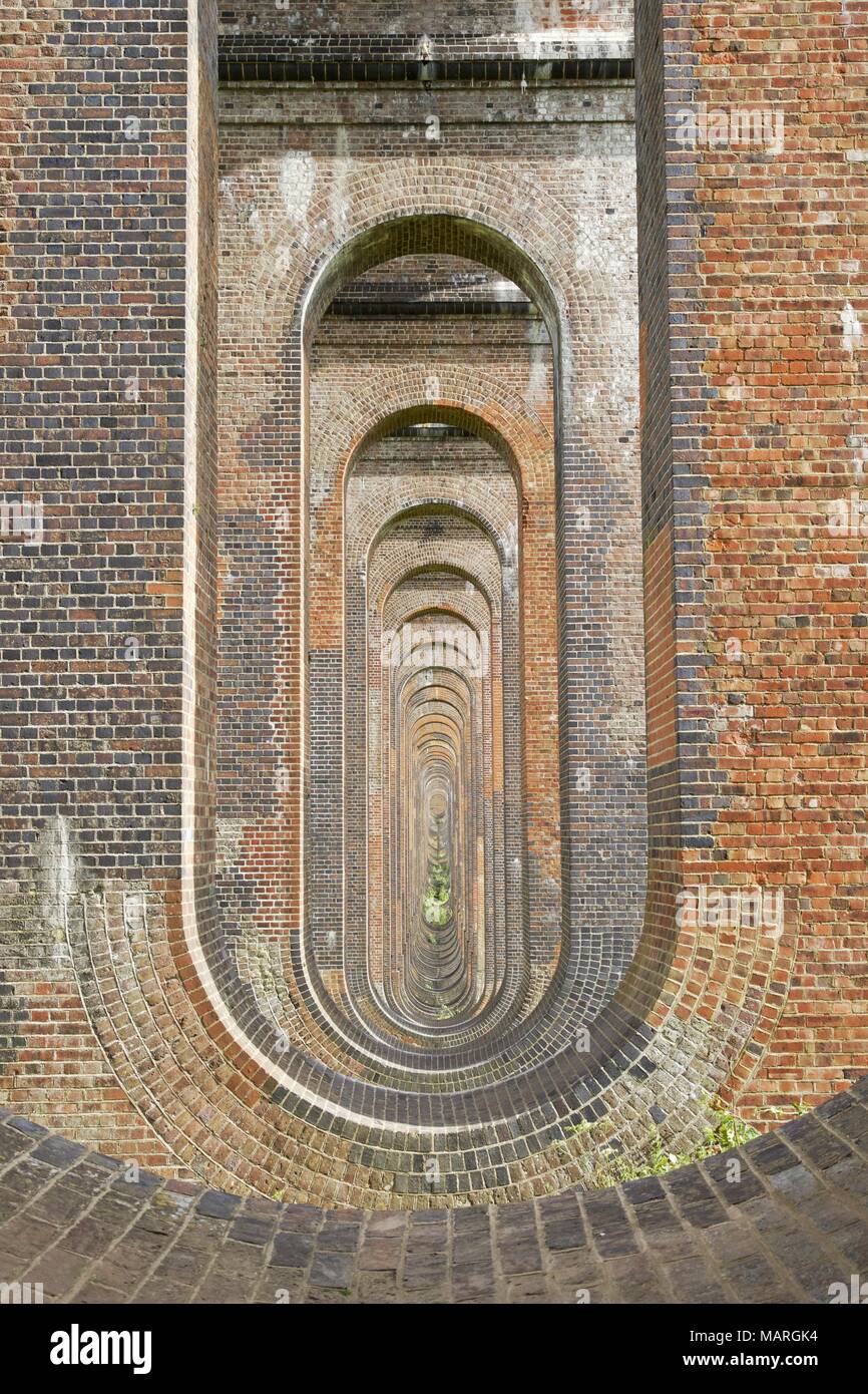 View along the brick arches of the Balcombe Railway Viaduct in West Sussex. Stock Photo