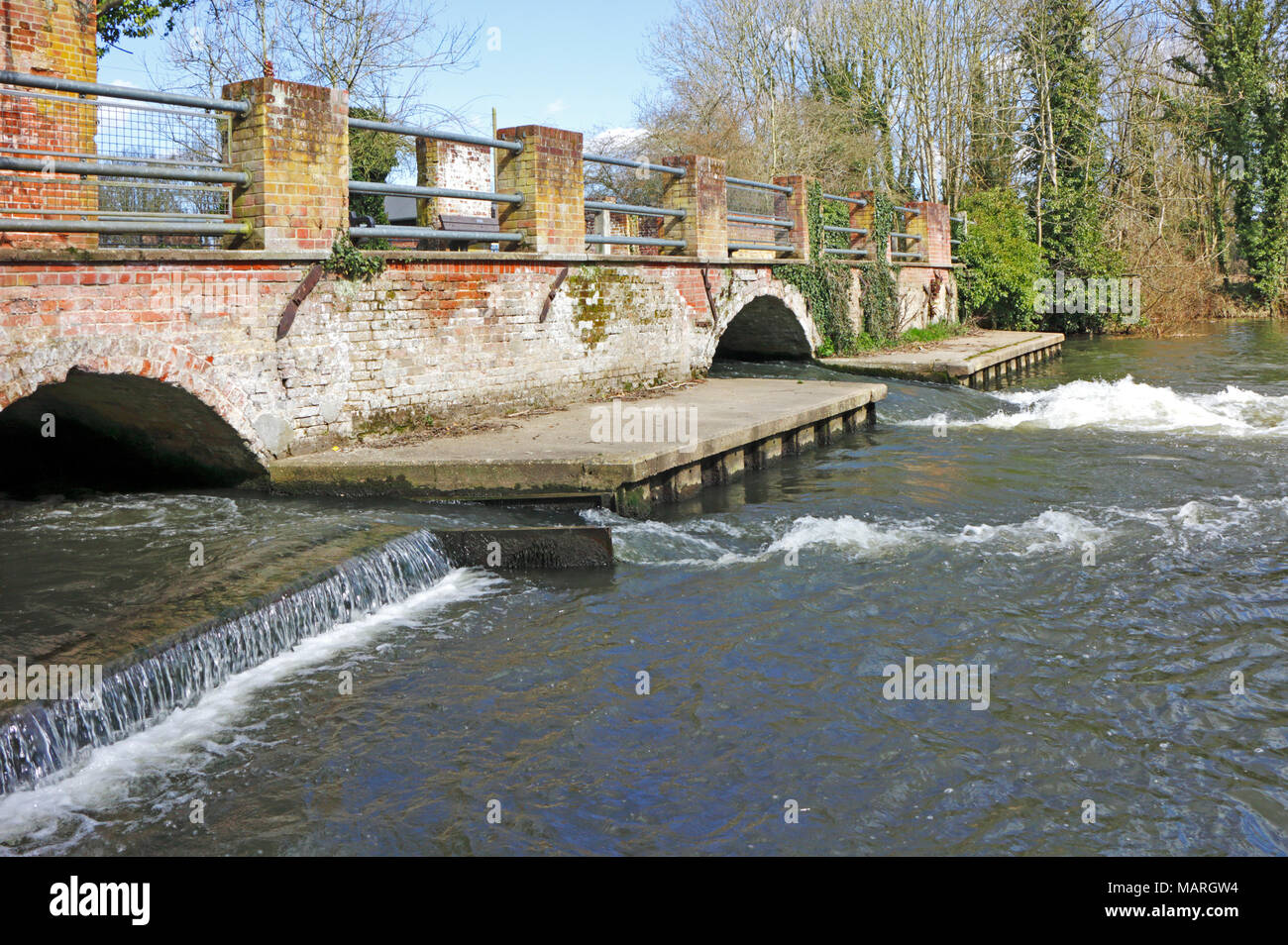 A view of the River Bure exiting the remains of the former watermill at Horstead, Norfolk, England, United Kingdom, Europe. Stock Photo