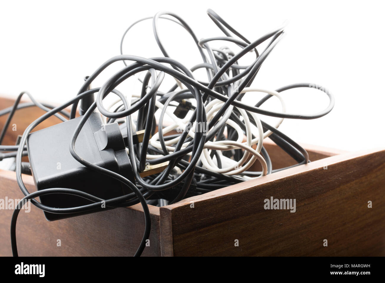 Old and defunct mobile phone, battery and usb cables that have been stuffed in a drawer. UK Stock Photo