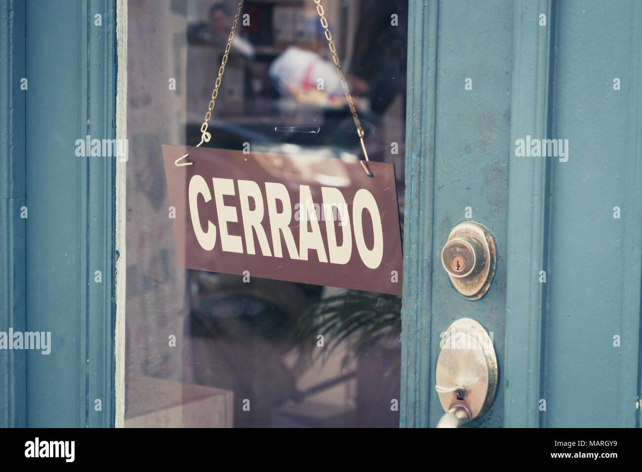 Cerrado (closed) sign on door - spanish word 'cerrado' (closed) on shop entrance Stock Photo