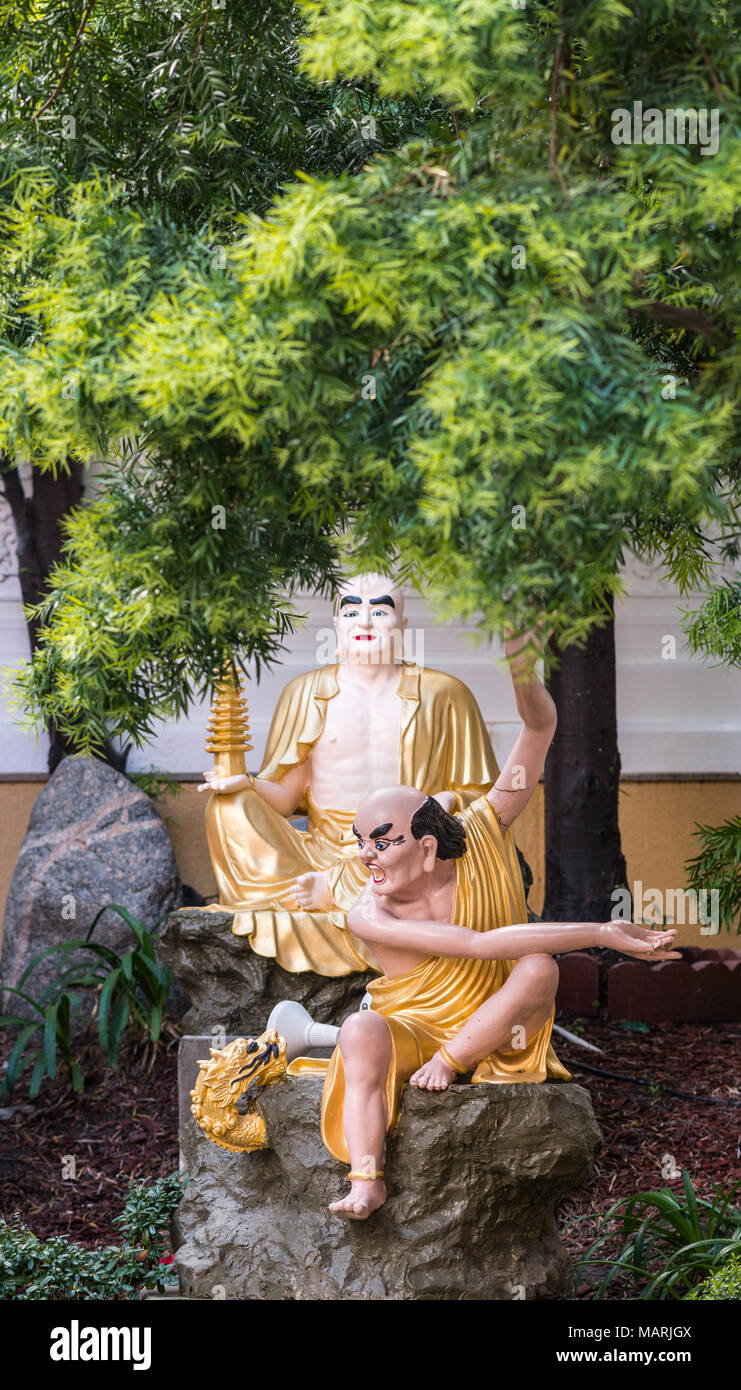 Hacienda Heights, CA, USA - March 23, 2018:  Closeup of golden draped Kalika with Pagoda and Mahkassapa yelling in Arhat garden at Hsi Lai Buddhist Te Stock Photo