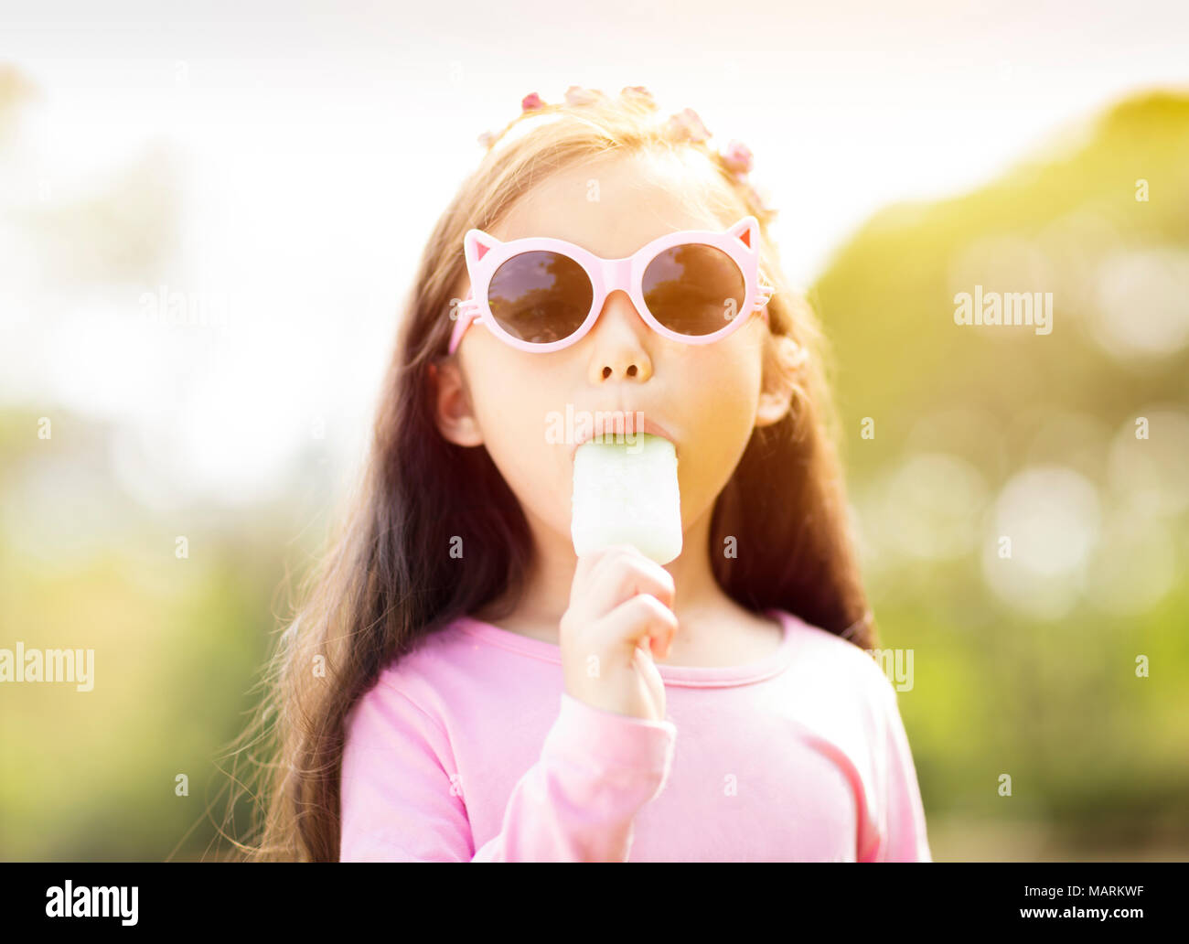 happy little girl eating popsicle at summertime Stock Photo - Alamy