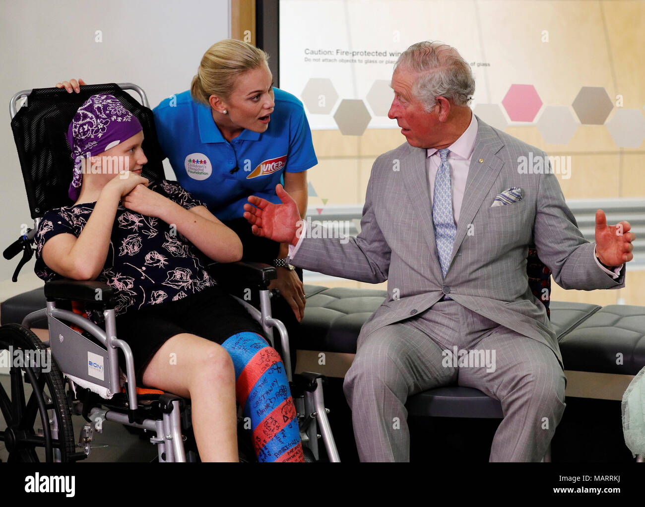 The Prince of Wales talks to Abigail Head, a Juiced TV star and Lady Cilento Children's Hospital patient, and Philippa Russell (in blue shirt), founder of Juiced TV, at Lady Cilento Children's Hospital in Brisbane, Australia. Stock Photo