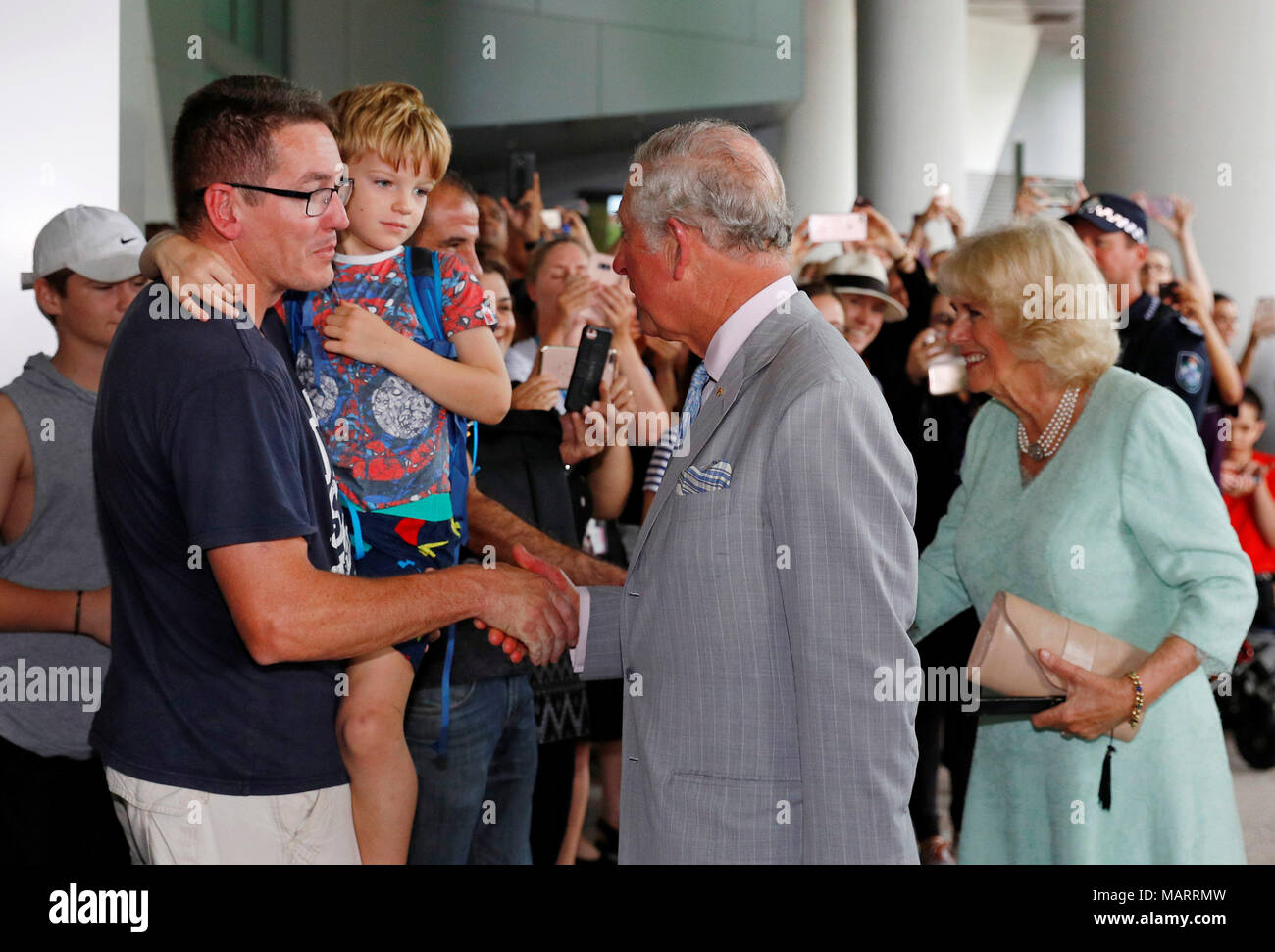 The Prince of Wales and the Duchess of Cornwall greet people during a