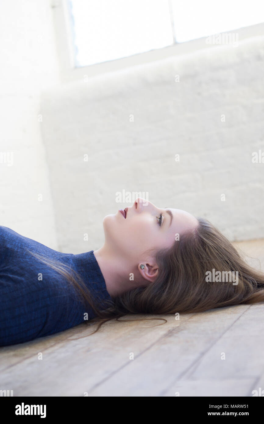 Beautiful Woman Laying Down On The Floor Looking Up Stock Photo Alamy