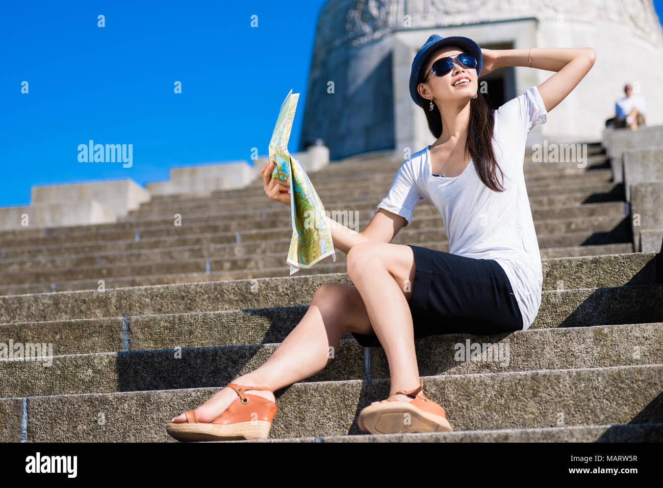 Asian female tourist smiling outdoors Stock Photo