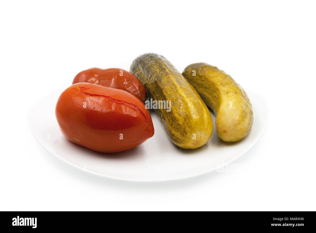 Pickled cucumbers and tomatoes. Isolated on white background. Stock Photo