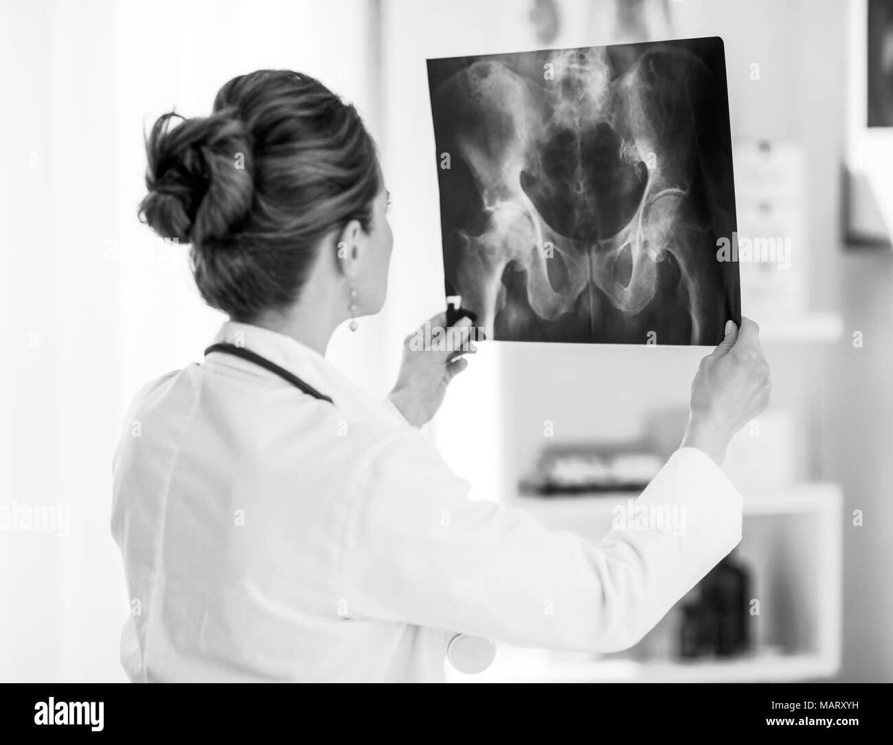 Doctor woman looking on fluorography. rear view Stock Photo