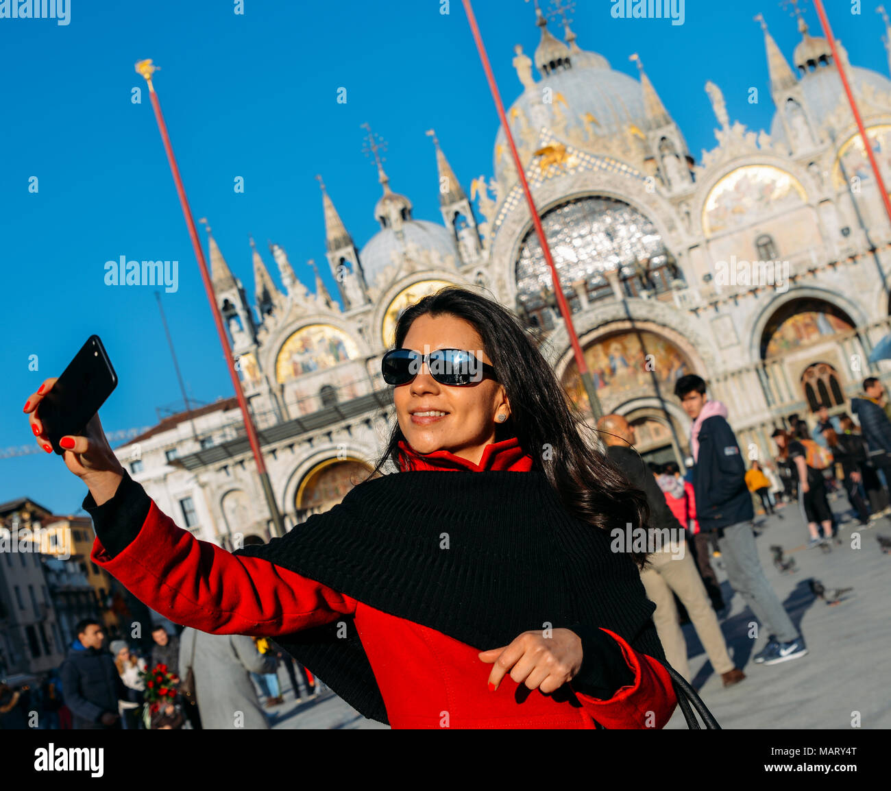 Close up of young female tourist taking selfie at San Marco square in Venice, Italy Stock Photo