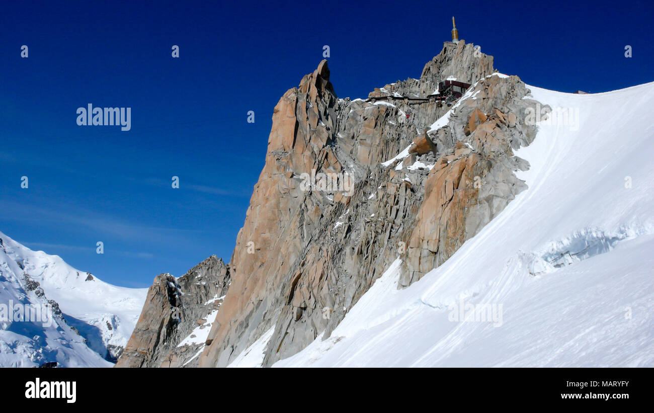 view of the famous Aiguille du Midi and surrounding glacier and ...