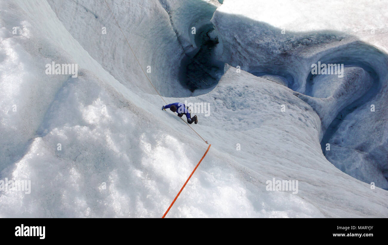 a mountain guide candidate training ice axe and rope skills on a