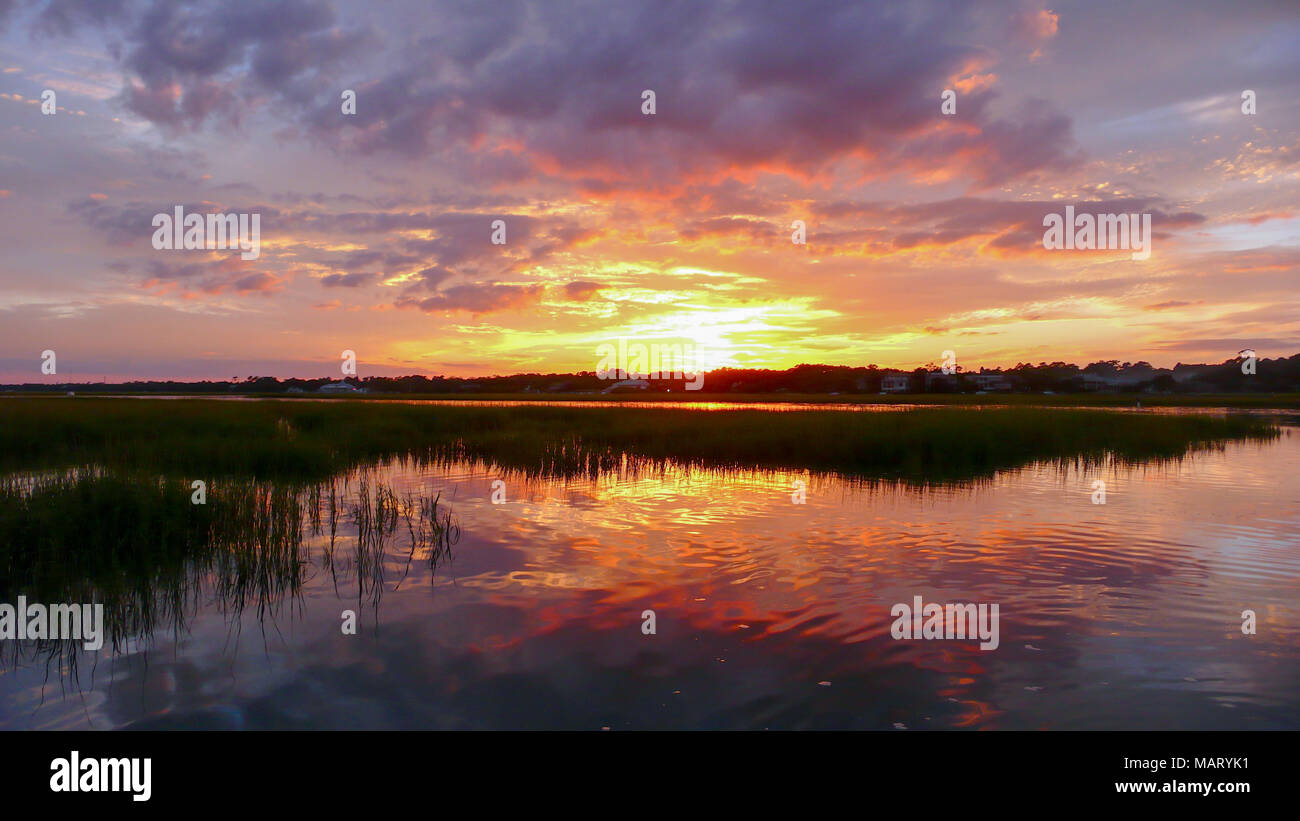 beautiful sunset setting over water and marshlands in the barrier