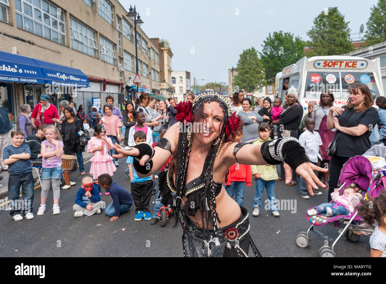 Street performer dancing during community street party, Queen's