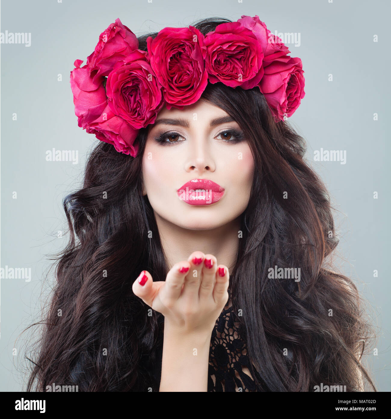 Beautiful Brunette Model Blowing a Kiss. Valentines Day Concept Stock Photo