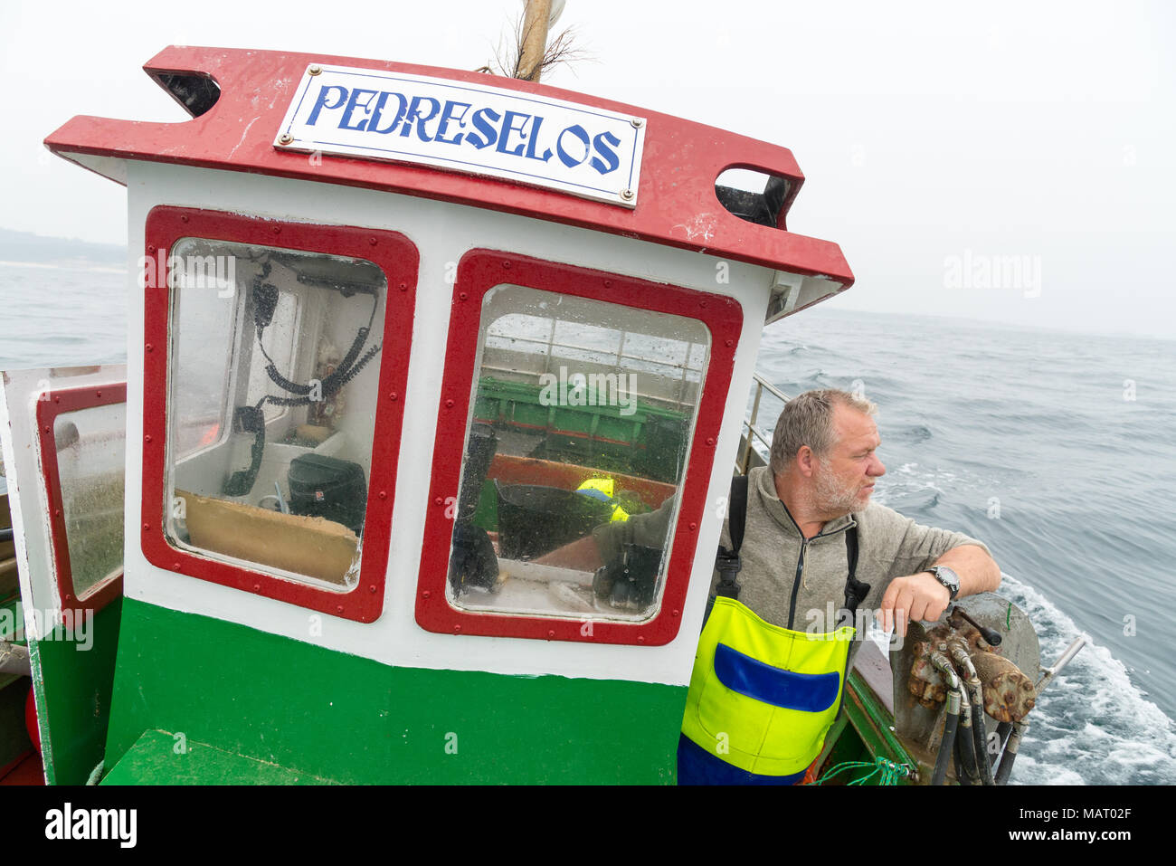 Fisherman on board his own boat, Galicia, Spain Stock Photo