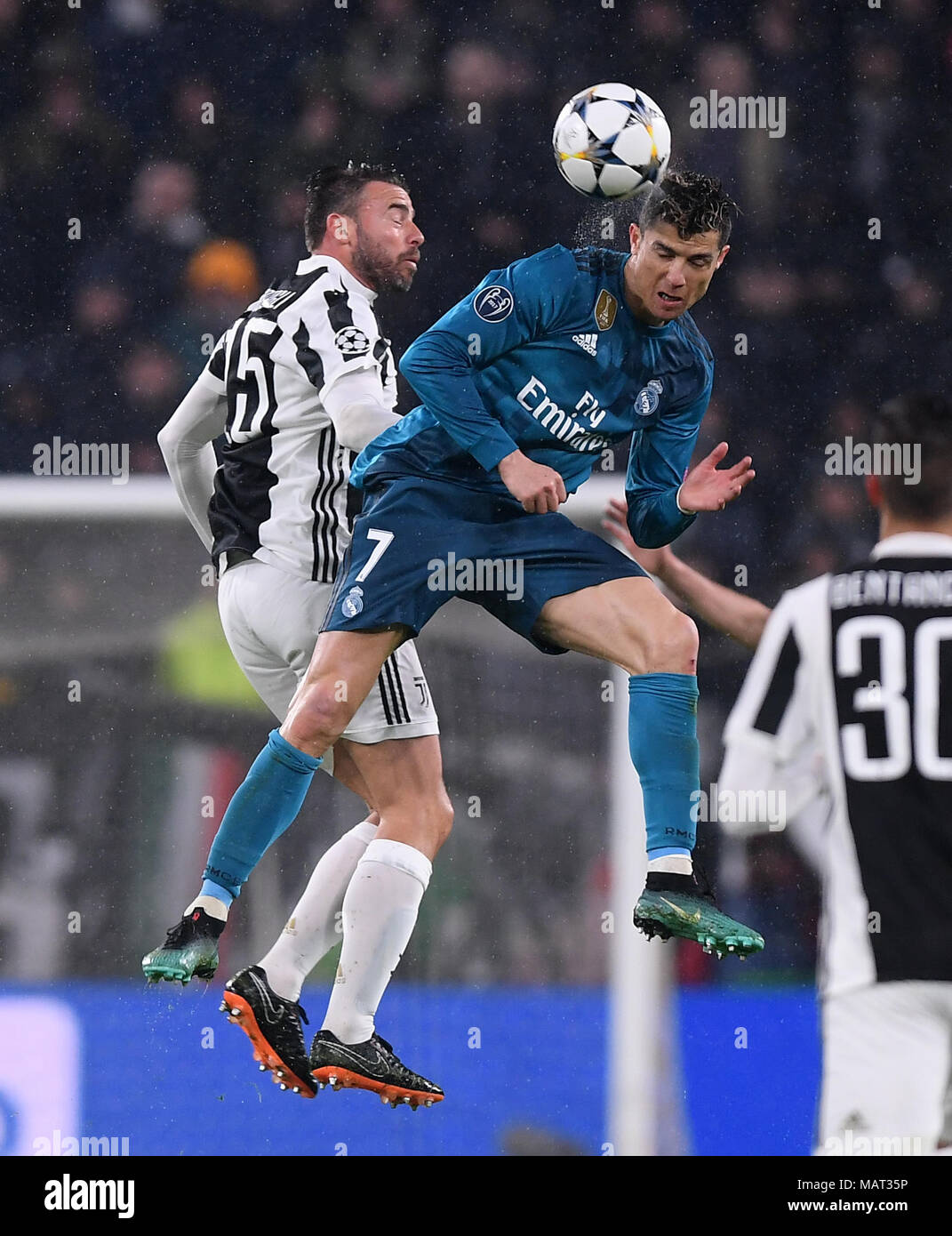 Turin, Italy. 3rd Apr, 2018. Real Madrid's Cristiano Ronaldo (R) vies with  Juventus' Andrea Barzagli during the UEFA Champions League quarterfinal  first leg soccer match between Juventus and Real Madrid in Turin,