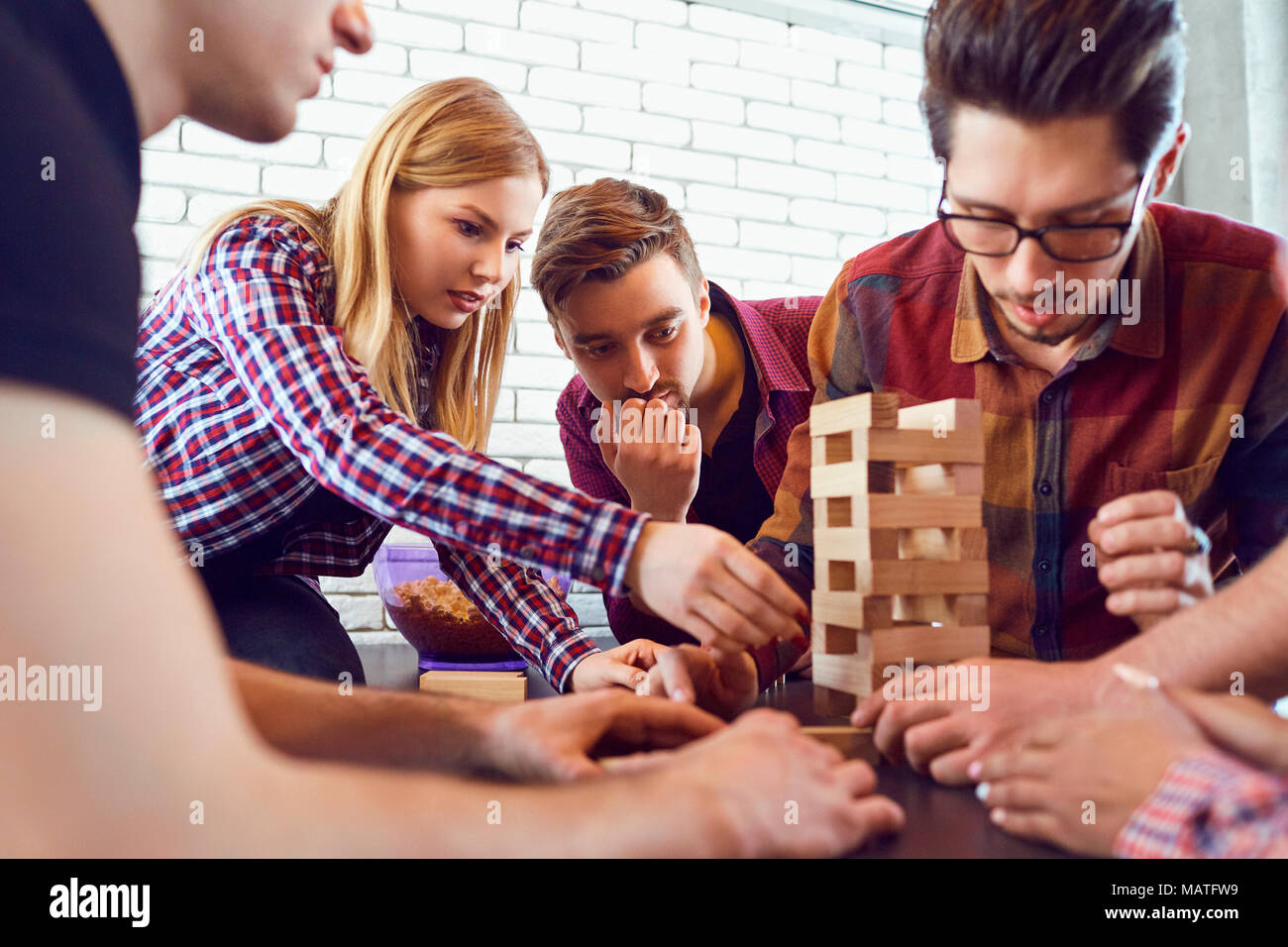 A cheerful group of friends play board games. Stock Photo