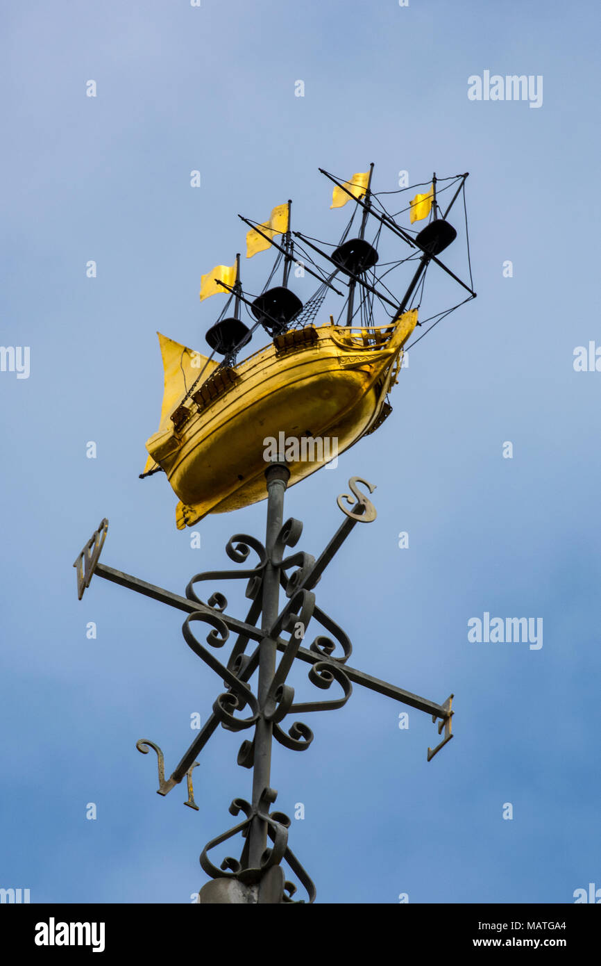 a weather vane on the top of a civic building neat the
