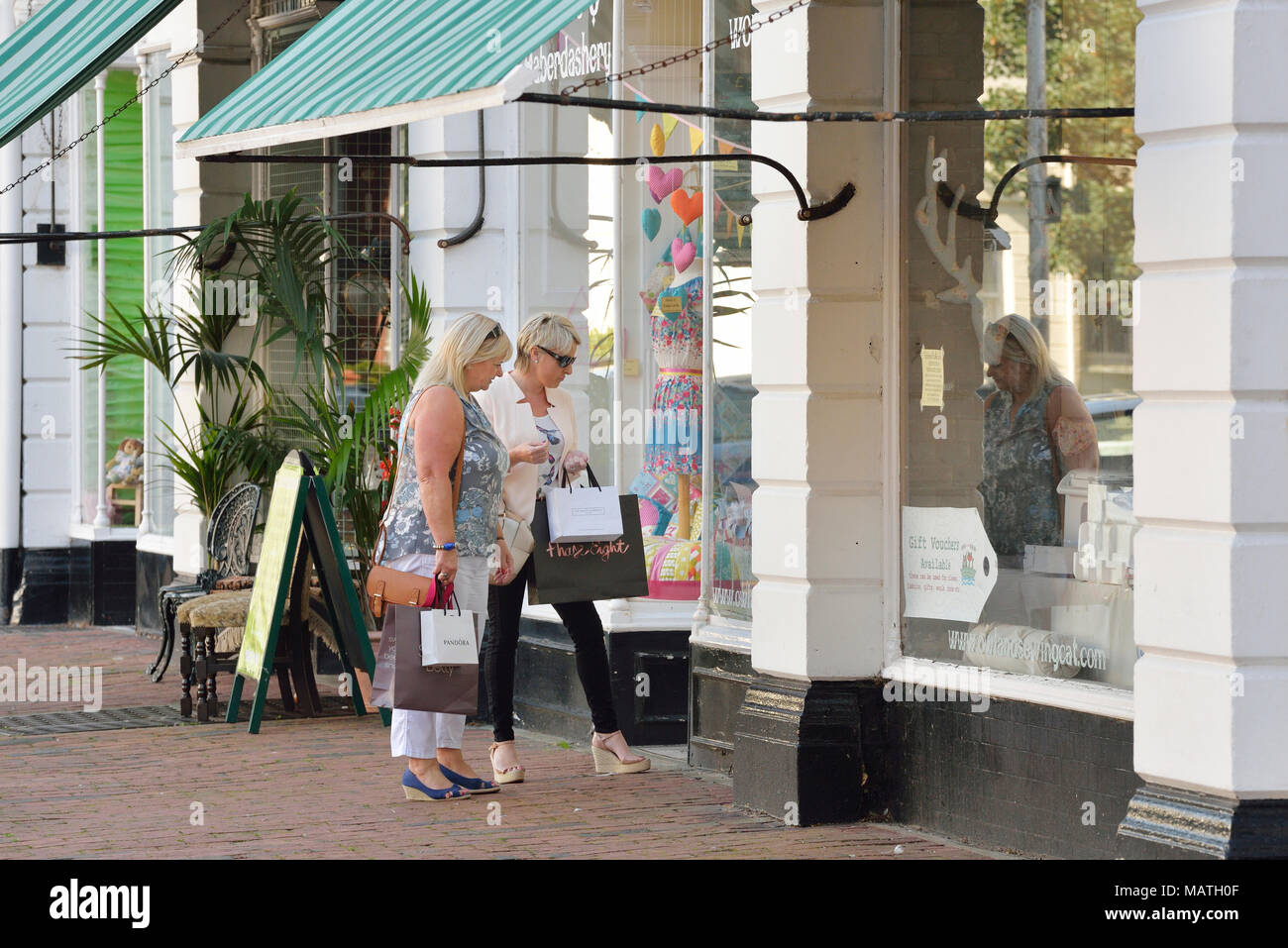 Two women shopping, Eastbourne, East Sussex, England, UK Stock Photo