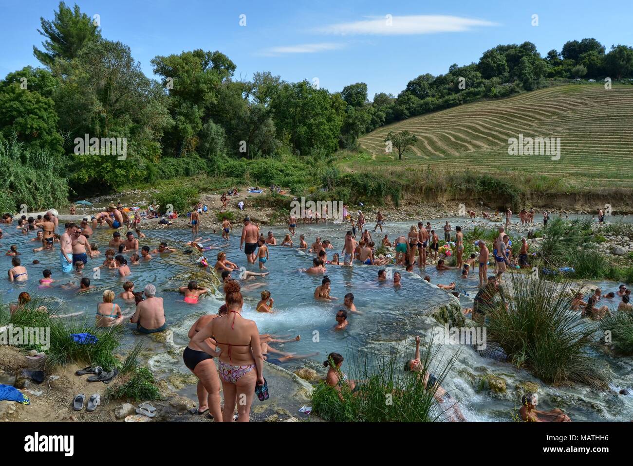 Terme di Saturnia, Tuscany, Italy 19 August 2014, 3.30 pm. Panoramic view  of the thermal baths, full of tourists swimming in the precious thermal  wate Stock Photo - Alamy