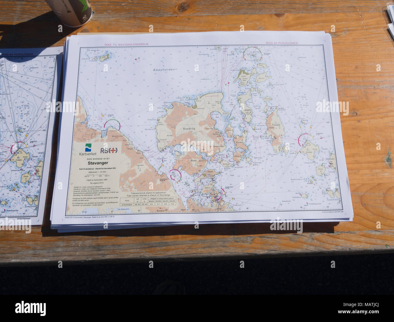 Stack of detailed nautical charts on a table, showing  Boknafjorden and the harbour of Stavanger Norway Stock Photo