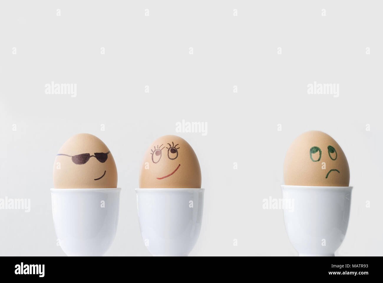 Eggs in a Love Triangle.  Two in love, one dejected. Stock Photo