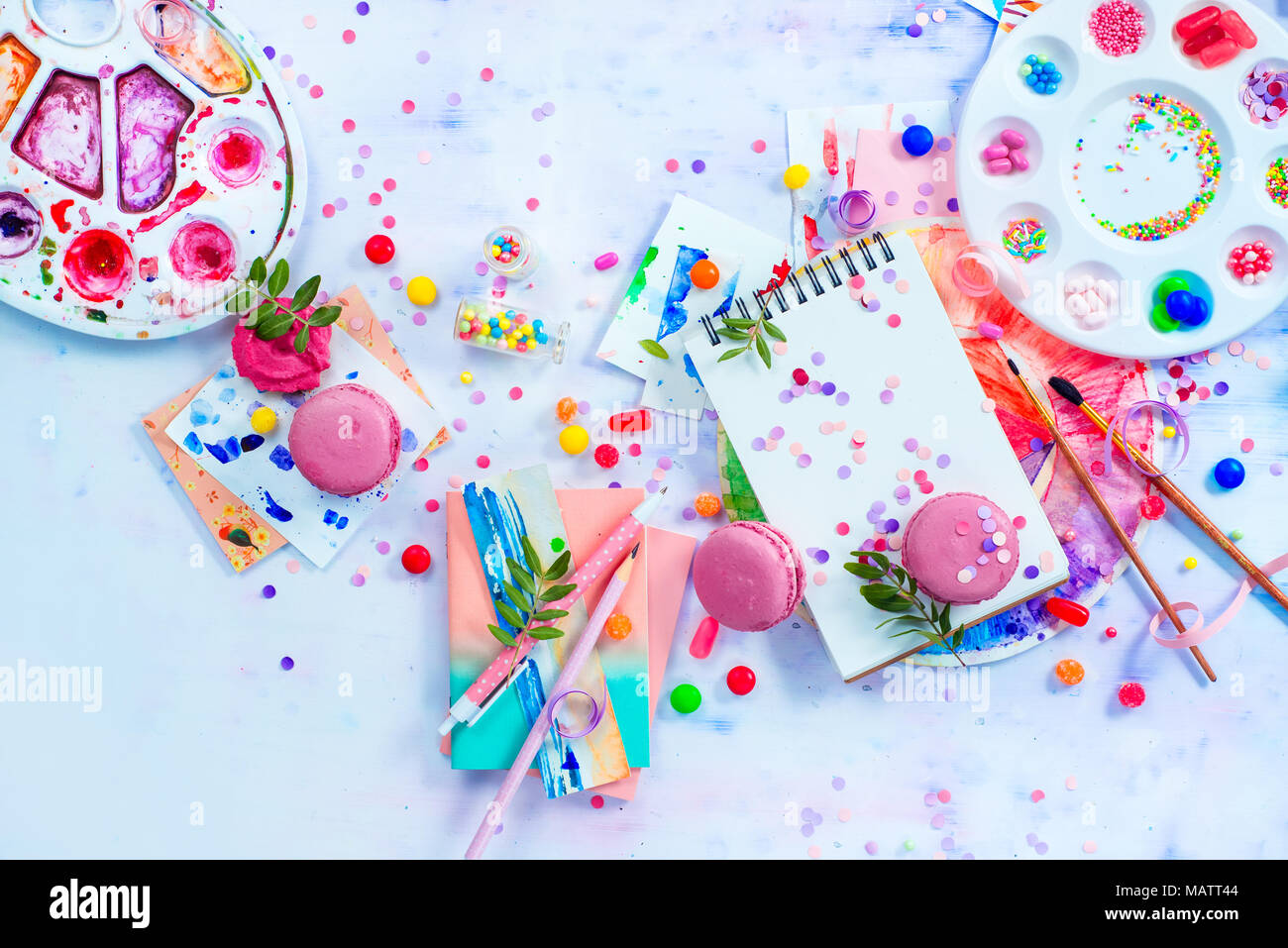 Sweettooth artist tools creative party concept. Pink macarons in a