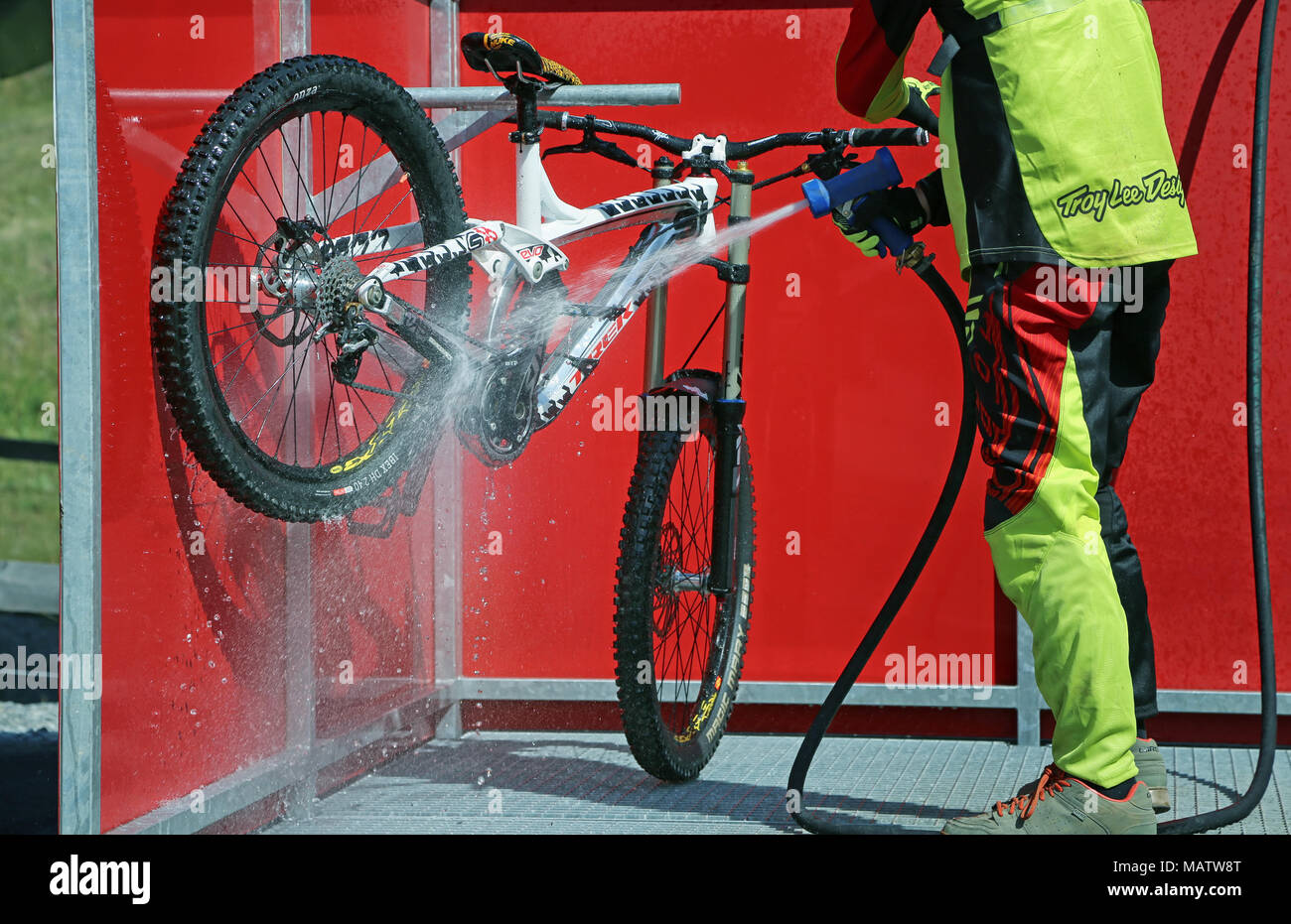 Man washing his Mountain Bike after Race Stock Photo