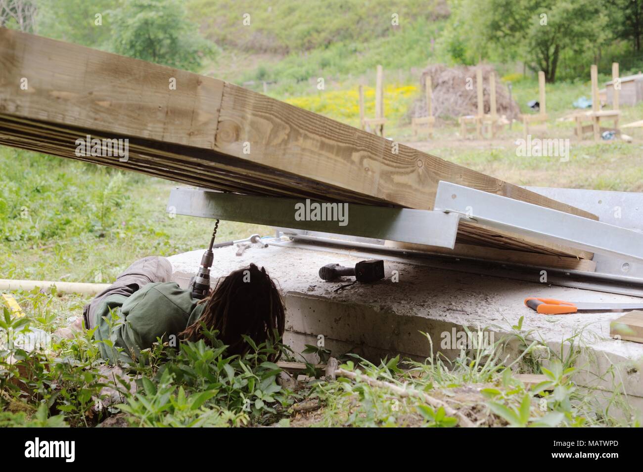 12 in a series of 32, building a timber footbridge. Fixing the steel end  support brackets. Stock Photo