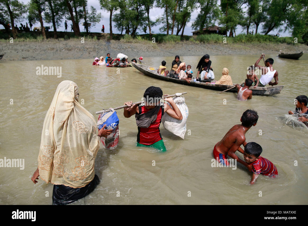 Rohingya muslims reaches the Bangladesh border after crossing a creek of the Naf river at Teknaf, Bangladesh. Stock Photo